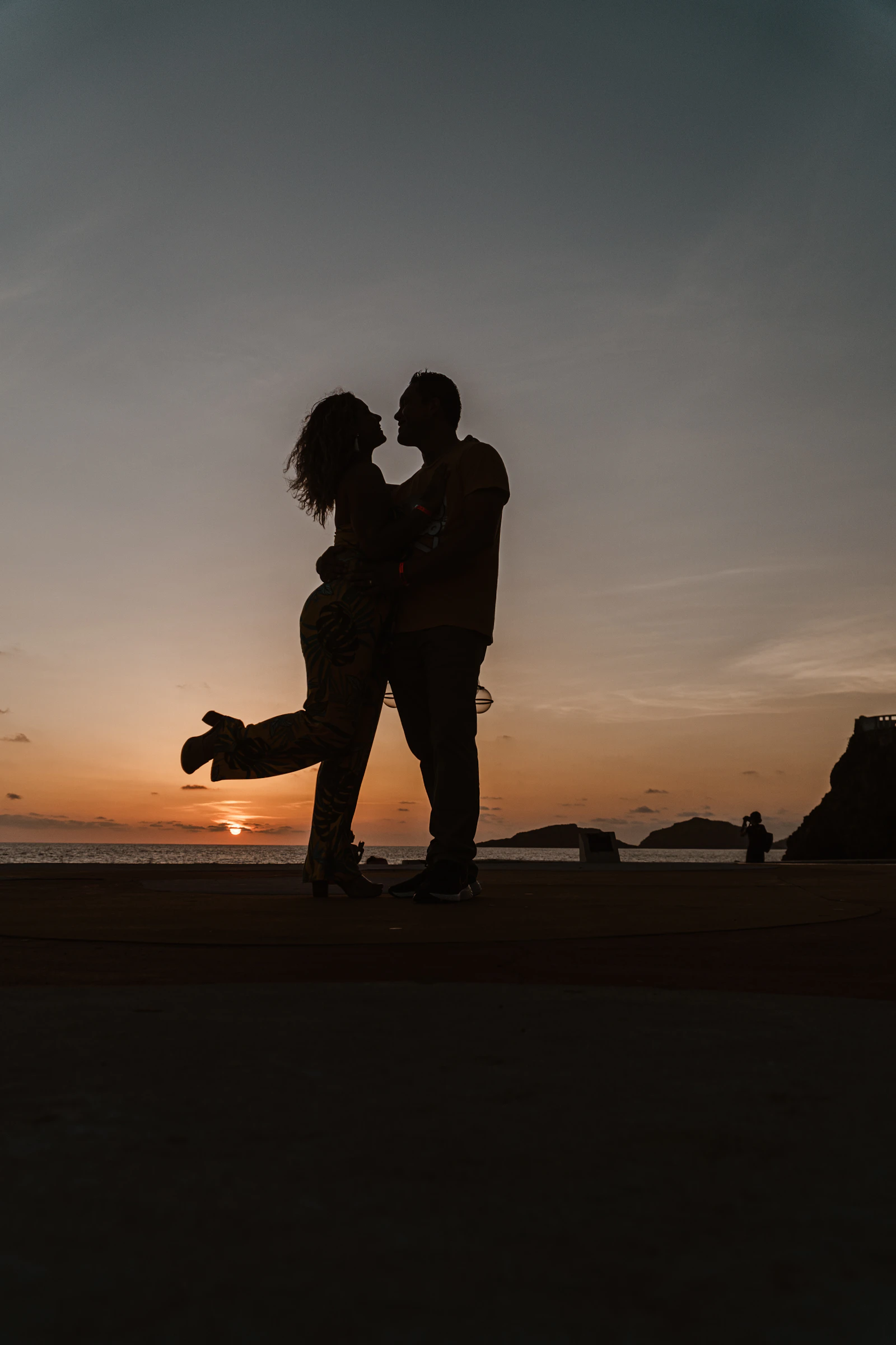 A couple embracing outside at sunset
